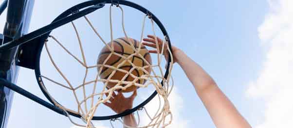 hand shooting basketball into the basket